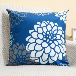 Dahlia flowers in white, on a blue cushion cover