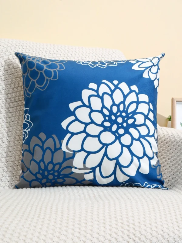 Dahlia flowers in white, on a blue cushion cover